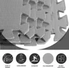 A close-up of stacked puzzle mats with icons and text describing their features. Produktbild-Vorschau
