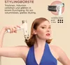 A woman is holding a white hair dryer with a brush attachment, demonstrating its use. The background is a plain, light beige color. Voir les images du produit