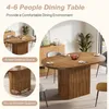 A dining table set up in a dining room with chairs and a sideboard. Podgląd zdjęcia produktu