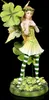 A figurine of a fairy with clover leaves and striped stockings.
