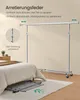 A SONGMICS clothes rack is shown assembled in a bedroom setting, with a folded version of the rack visible under the bed. Produktbild-Vorschau