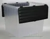 A clear studio shot of a transparent storage box with black clips and a black protective cover. Produktbild-Vorschau