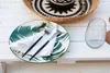 A table setting with a plate, cutlery, napkin, and a glass. Náhľad obrázku produktu