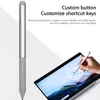 A stylus pen is shown next to a laptop, with text describing its features. Voir les images du produit