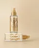 Two bottles of Wella Oil Reflections hair oil are displayed against a light beige background. One bottle stands upright, and the other lies horizontally in front of it. Produktbild-Vorschau