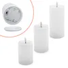 Three white LED candles of varying heights are arranged on a white background. The candle on the left is shown from the bottom, revealing the battery compartment and a separate base. The other two candles are shown from the top with their LED flames. Voir les images du produit
