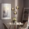 A dining table set with pendant lights above, a painting on the wall, and a ladder shelf in the background. Produktbild-Vorschau