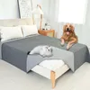 A dog and a cat are on a bed with a protective cover. Náhled obrázku produktu