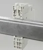 A close-up shot of a white electrical component mounted on a metal rail. Produktbild-Vorschau