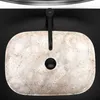 A top-down view of a beige oval countertop sink with a black faucet. Anteprima dell’immagine prodotto