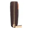 A side view of a brown wallet with a tan accent and gold zipper. Anteprima dell’immagine prodotto