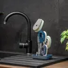 A kitchen sink area with a black faucet and a cleaning brush set with a dispenser and stand. Anteprima dell’immagine prodotto