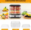 A food dehydrator with various fruits and vegetables, along with separate trays, displayed on a kitchen counter. Voir les images du produit