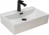 A white rectangular sink with a black faucet and drain.
