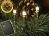 Close-up of LED lights on a Christmas tree branch with a pine cone in the background. Produktbild-Vorschau