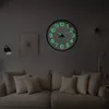 A living room with a couch and a glowing clock on the wall. Voir les images du produit