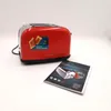 A red toaster and its instruction manual are placed on a white surface. Produktbild-Vorschau