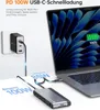 A laptop is being charged and connected to a docking station via a USB-C cable. A power adapter is plugged into a wall outlet. Produktbild-Vorschau