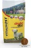 A bag of dog food with a picture of a dog and a landscape on it, and a single piece of kibble in the foreground. Produktbild-Vorschau