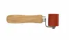A product shot of a roller tool with a wooden handle and a red silicone roller. Náhled obrázku produktu