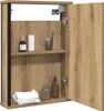 An open medicine cabinet with shelves holding toiletries and towels. Voir les images du produit