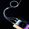 A close-up shot of a light blue multi-charging cable connected to three smartphones. Produktbild-Vorschau