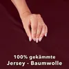 A hand resting on a dark red fabric, with text overlay. Produktbild-Vorschau