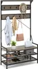 A coat rack and shoe bench with various items on it. Náhled obrázku produktu