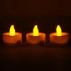 Three LED tea lights with yellow flames are arranged in a row against a dark background. Produktbild-Vorschau