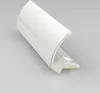 A white coated balcony door handle is shown on a reflective surface. Produktbild-Vorschau