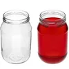 Two glass jars are shown side-by-side against a white background. One jar is empty and clear, while the other is filled with a red liquid. Podgląd zdjęcia produktu