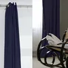 A split image showing a navy blue curtain on the left and a rocking chair with a white blanket on the right, with navy blue curtains in the background. Produktbild-Vorschau