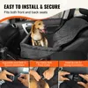A dog sitting in a car seat cover in a car. Náhled obrázku produktu