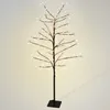 A decorative tree with white LED lights on a dark stand, against a light gray background. Podgląd zdjęcia produktu