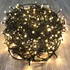A tangled pile of warm white LED string lights on a wooden floor. Produktbild-Vorschau