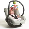 A baby is sitting in a car seat with a mobile toy attached to the handle. Voir les images du produit