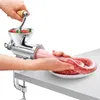 A person is using a manual meat grinder to make sausages. Produktbild-Vorschau