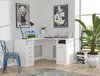 A white corner desk with drawers and a cabinet, set up in a home office or study area with artwork and a plant. Náhled obrázku produktu