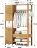 A bamboo wardrobe with clothes hanging and folded items on shelves. Produktbild-Vorschau