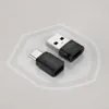 Two USB adapters are shown on a light gray background with a subtle hexagonal overlay. Produktbild-Vorschau