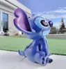 A blue Stitch figurine is sitting on a patio in front of a modern house. Produktbild-Vorschau