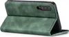 A green flip case for a smartphone is shown open, with the phone inserted. Produktbild-Vorschau