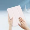 Hands holding a pink tablet case with a folded cover. Produktbild-Vorschau