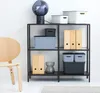 A shelf with storage boxes and a lamp. Produktbild-Vorschau