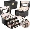 A collage of black jewelry boxes with gold accents, showcasing different angles and interior compartments. Náhľad obrázku produktu