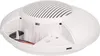 A white, oval-shaped device with a grated top, shown from a slightly elevated side angle. The front section is open, revealing internal wiring and mounting points. Podgląd zdjęcia produktu