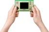 Hands holding a Nintendo Game & Watch console. Produktbild-Vorschau