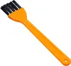 A close-up studio shot of an orange and black cleaning brush against a white background. Produktbild-Vorschau