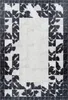 A rectangular rug with a patchwork design of black and white squares and a central white area. Produktbild-Vorschau