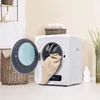 A mini washing machine in a laundry room setting. Produktbild-Vorschau